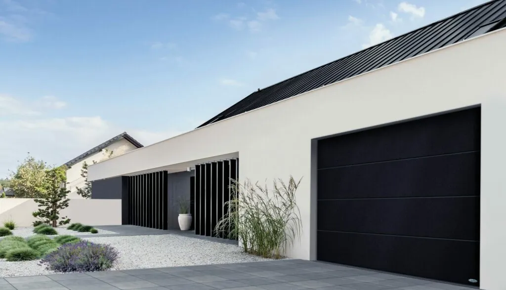 Porte de garage sectionnelle noire sur une maison blanche